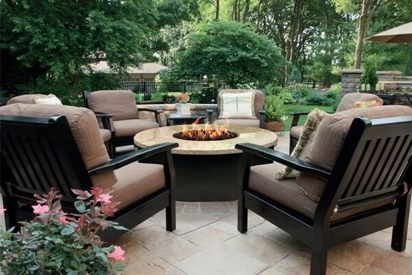 outdoor propane fire pit with chairs around it