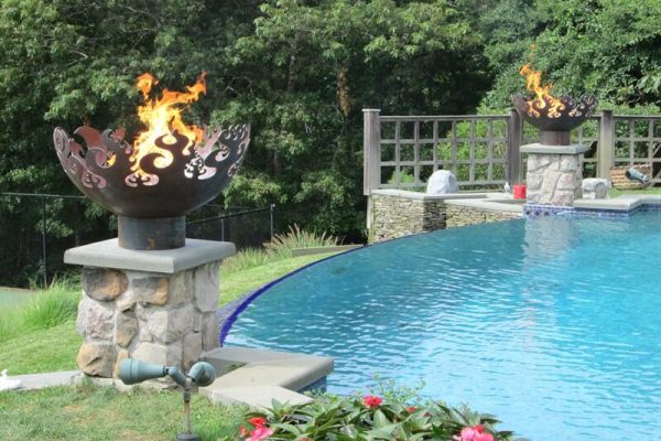 propane fire bowls next to pool
