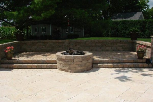circular fire pit outside on stone patio