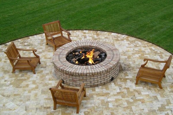 circular outdoor fire pit with chairs on a veranda
