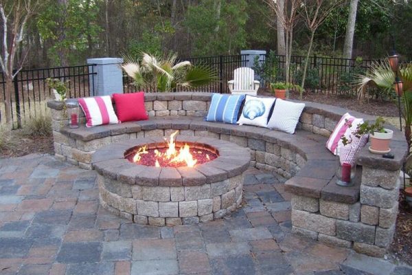 circular outdoor fire pit with stone semi circle bench