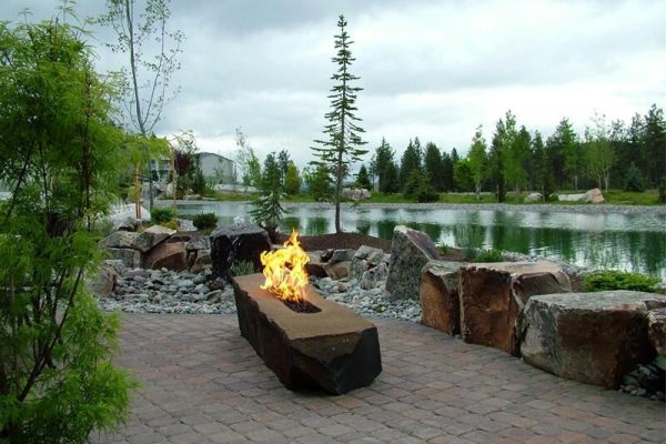 outdoor propane fire pit next to lake